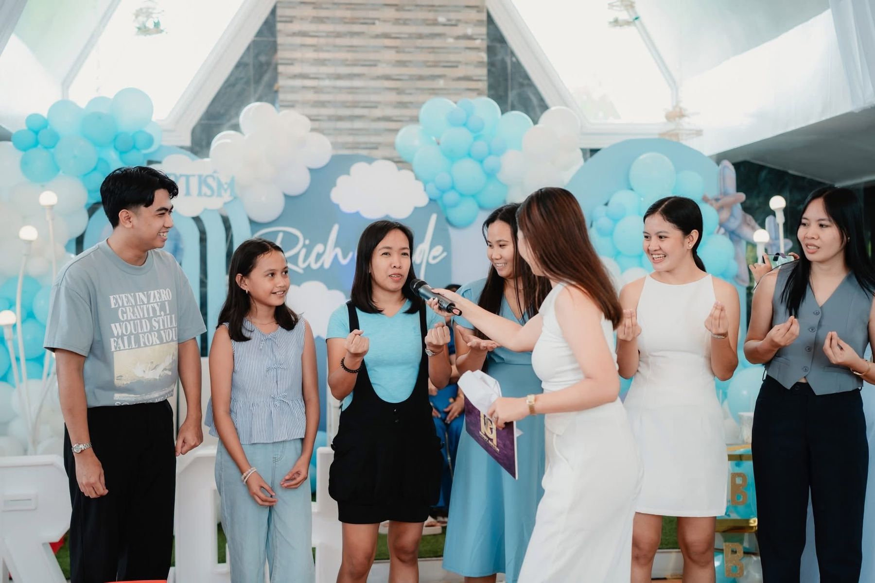 Host Mitch interviewing a group of young guests during a game